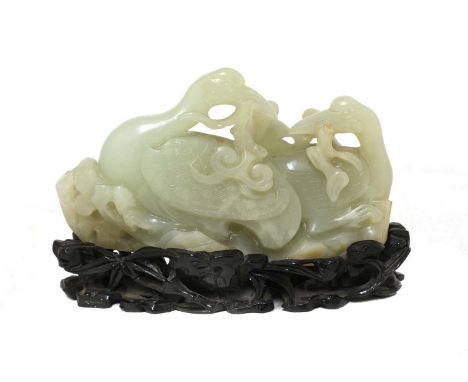 A Chinese jade carving,Qing dynasty (1644-1911), of two cranes seated on a rock by bamboo, one holding a lingzhi branch in it