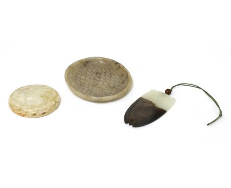 A collection of three Chinese jade carvings, comprising: a cicada pendant, 6cm long, a disc, with a chilong in relief, 5.2cm 