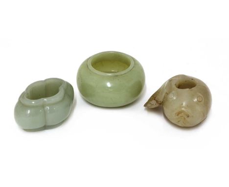 A collection of three Chinese jade waterpots,Qing dynasty (1644-1911), comprising:one of quadrilobed form, the stone of celad