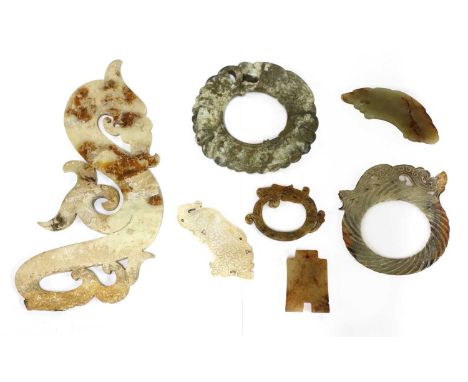 A collection of Chinese jade carvings, carved as dragons in the archaic style, 6.4 to 25cm long, and a pendant, in the shape 