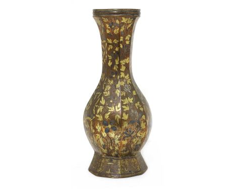 A bronze vase, possibly Tibetan or Persian, of octagonal form, inlaid with scrolling foliage in silver and gilt, above Eight 