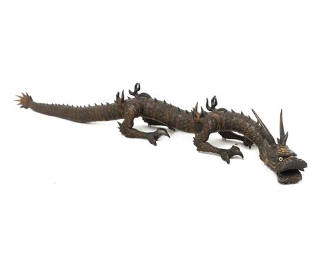A Japanese articulated wood okimono,Meiji period (1868-1912), of a naturalistically rendered dragon, the body intricately car