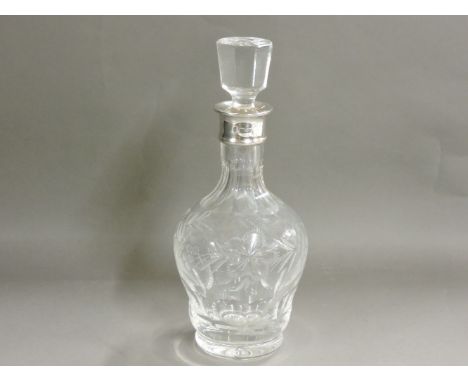 A silver mounted cut glass and etched decanter, 29cm