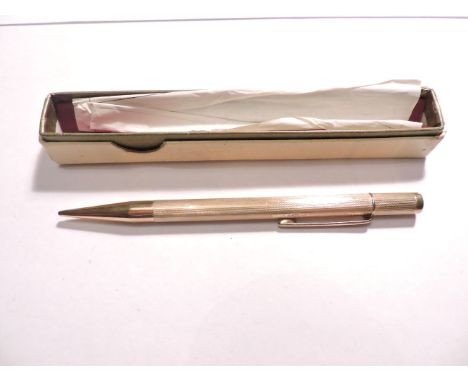 A 9ct gold twist action propelling pencil, with engine turned decoration