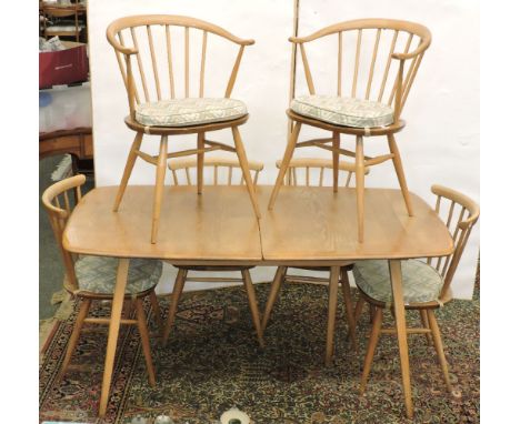 An Ercol extending dining table, with folding double leaf, and six chairs, 153 x 83cm closed, 225cm long open