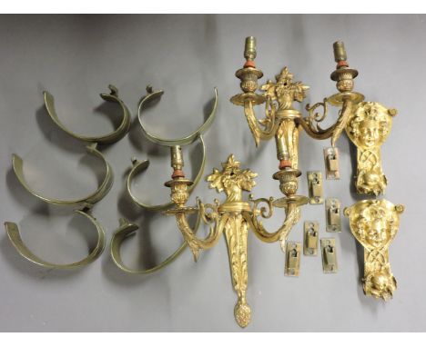 A set of six brass curtain backs, a pair of gilt bronze two branch wall lights, and a pair of furniture mounts
