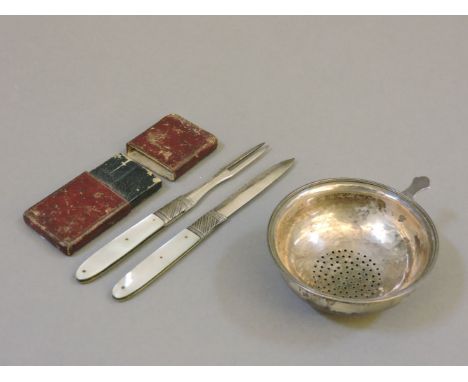 A Georgian silver folding fruit knife and fork, with mother of pearl handles, in a leather case, and a Georgian silver wine f