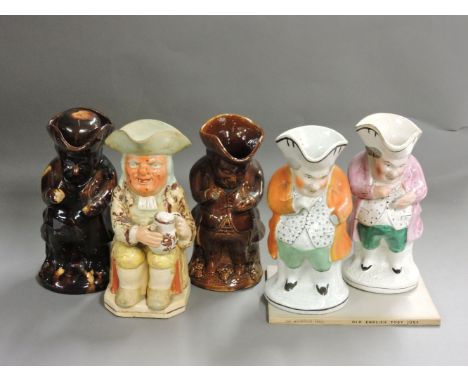 Five 19th century Toby jugs, two treacle glazed, one Ralph wood type seated with an orange spotted face, one handleless, anot