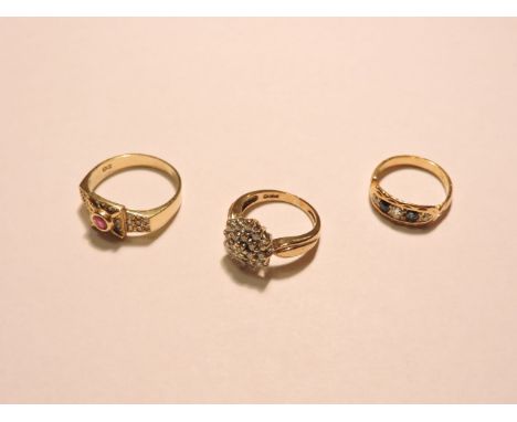 A 9ct gold diamond set cluster ring, an 18ct gold ruby and diamond pavé set ring, and an Edwardian diamond and sapphire boat 