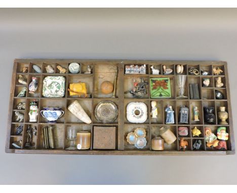 A wooden print tray, with contents, including china, glass, bronze,  scrimshaw, ornaments, etc