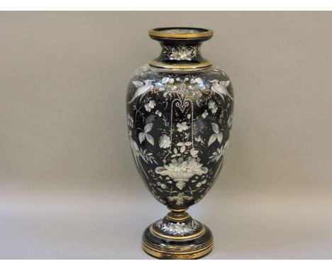 A Victorian amethyst glass vase, with overpainted bird, leaf and flower decoration, 37cm high