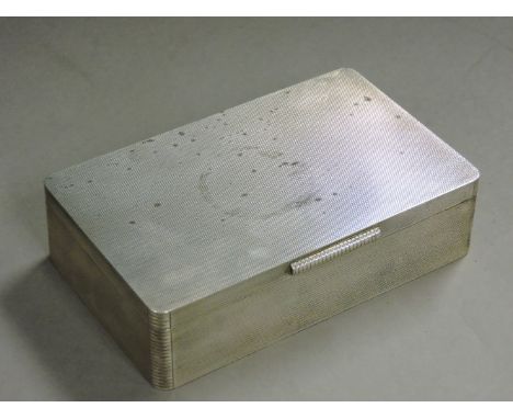 A silver cigarette box, by Padgett & Braham Ltd, London 1964, of engine turned rectangular form, stamped 'Harrods London S W'