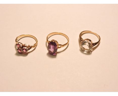 A single stone colour change synthetic sapphire ring, a three stone ring possibly pink tourmaline, and a single stone white t