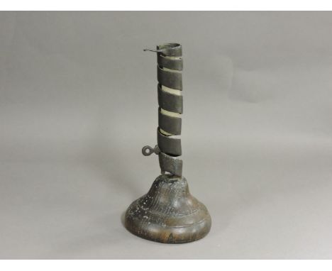 A 17th century coil candlestick, with ejector and fruitwood base, 21cm high