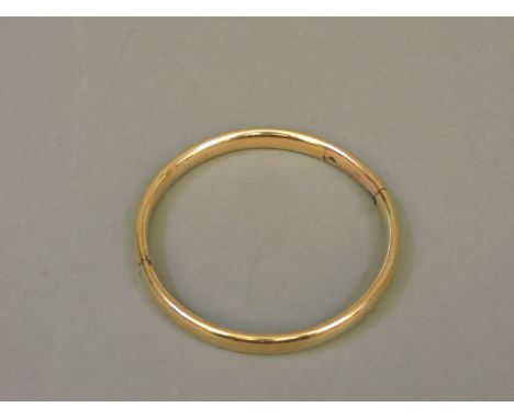 A gold slave bangle, with a later inserted section, solder may not pass assay