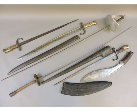 Two French chassepot bayonets, a kukri in scabbard, and two fencing foils