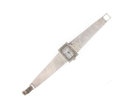 UNIVERSAL GENEVE - a lady's 18k white gold bracelet watch reference 48, silvered bark-effect dial with black baton markers, s