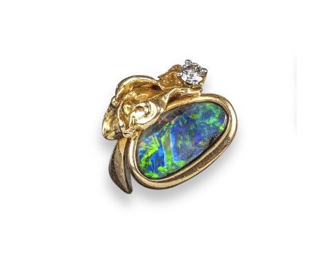 A boulder opal and diamond ring, the oval opal within textured gold surround, set with a diamond in yellow gold, size J appro