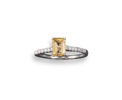 An orange topaz and diamond ring, the emerald-cut topaz is set with circular-cut shoulder diamonds in platinum, size M 1/2