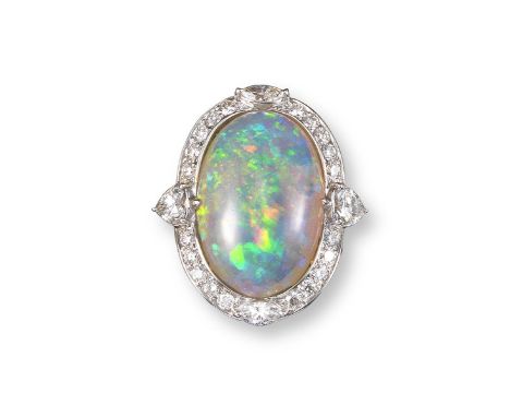 An opal and diamond cluster ring, the oval solid white opal is set within a surround of circular-cut diamonds, quartered with