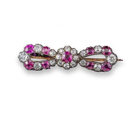 A late Victorian ruby and diamond bow brooch, alternately-set with graduated circular-cut rubies and diamonds in silver and g