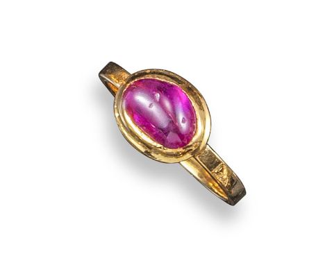 A ruby solitaire ring, the ruby cabochon is rubover-set in yellow gold, size M (approximately)