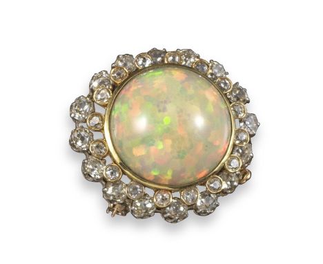 An opal and diamond circular brooch, the large opal cabochon is set within two surrounds of graduated cushion-shaped diamonds