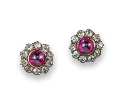 A pair of ruby and diamond cluster ear studs, the ruby cabochons are set within a surround of circular-cut diamonds in silver