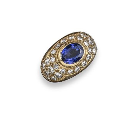 A sapphire and diamond bombe-shaped ring, the oval-shaped sapphire is rubover set within a surround of circular-cut diamonds 