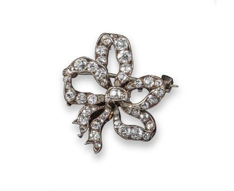 A late 19th century diamond bow brooch, set with graduated cushion-shaped diamonds in silver and gold, 2.5cm wide, case