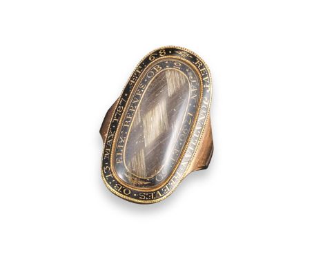 A late 18th century gold and enamel mourning ring, with plaited hair to the centre and inscription to the outside for Reveren