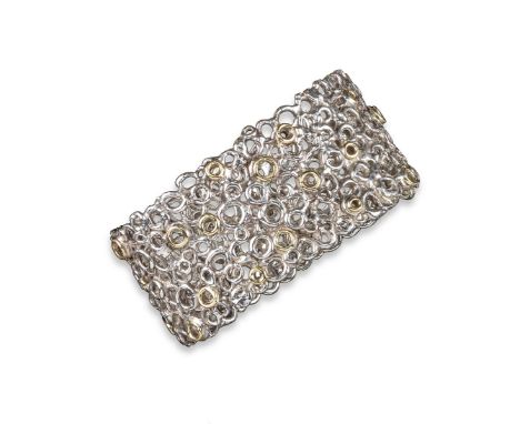 An abstract silver bangle by Margaret Turner, comprising layer silver loops, some decorated with gold, makers mark and London