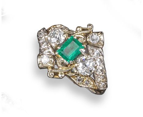 An emerald and diamond cluster ring, the baguette-shaped emerald set with graduated circular-cut diamonds in white gold, size