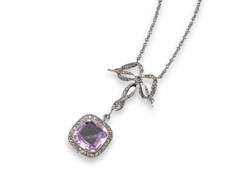 A pink topaz and diamond pendant, the cushion-shaped topaz is millegrain-set within a surround of rose-cut diamonds, set bene