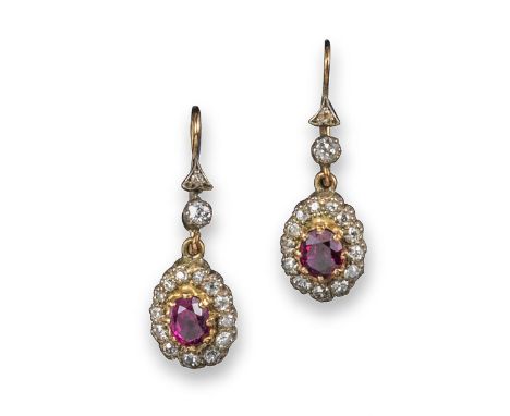 A pair of ruby and diamond drop earrings, the pear-shaped rubies are set within a diamond surround and suspend from two furth
