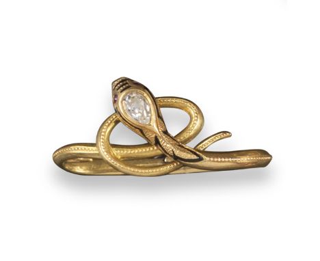 A 19th century diamond set serpent scarf pin, the realistically designed snake with a diamond set head, black enamel decorati