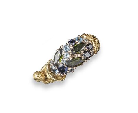 A gem-set gold ring by Stuart Devlin, set with tourmalines, aquamarines and sapphires within cornucopia design and a cherub, 