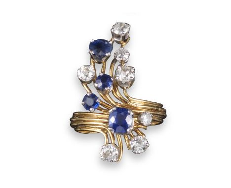 A sapphire and diamond ring, of scroll form and set with graduated cushion-shaped and circular-cut sapphires and diamonds in 