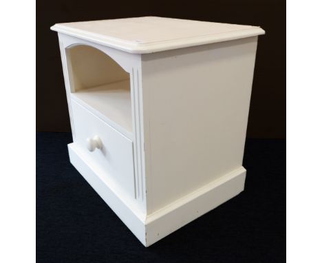 A modern cream painted pine bedside unit: the moulded top an open shelf section and single drawer below, raised on plinth bas