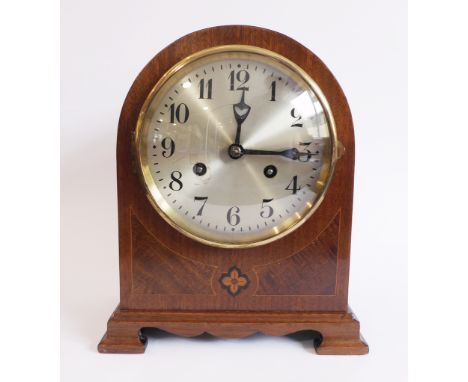 A good quality early 20th century mahogany-cased eight-day mantle clock: the dial with Arabic numerals above a central marque