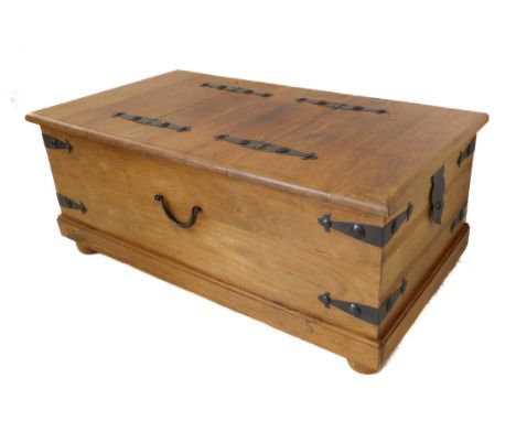 A modern Eastern-style bound trunk / coffee-table on castors: two hinged opening end-flaps (110 cm wide x 60 cm deep x 46 cm 