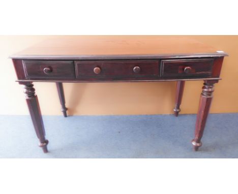 A William IV style rosewood writing table: the thumbnail-moulded top above three frieze drawers and raised on tapering octago