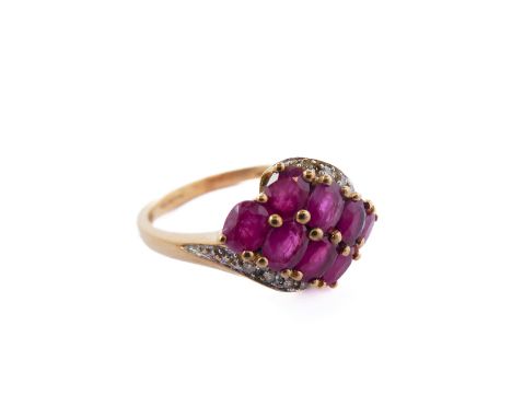 A 9-carat gold dress ring set with rubies and small diamonds (boxed), ring size P