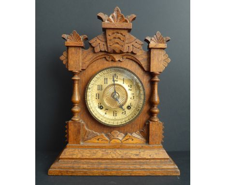 A late 19th century eight-day Tivoli mantle clock by Ansonia: carved oak case,&nbsp;the movement striking on a gong (38.5 cm 