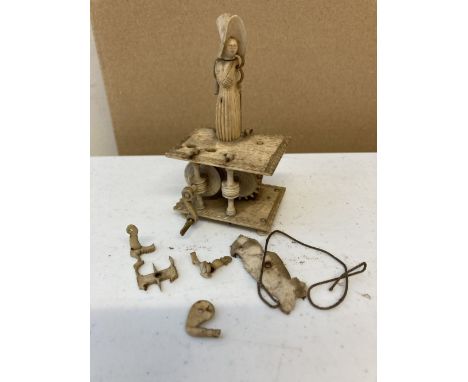 Automaton. A Napoleonic period bone prisoner of war automaton circa 1800, carved as a woman who should be operating a spinnin
