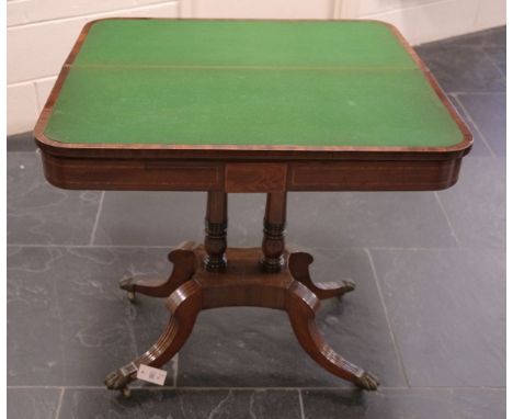 Card Table. A Regency mahogany fold-over card table, the rectangular top with rounded corners, satinwood and rosewood edges, 