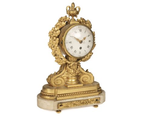 Mantel Clock. A late 19th century French mantel clock, the elaborate classical ormolu case with urn finial, and wreath border