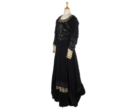 Dress. An Arts &amp; Crafts velvet gown, circa 1900, handmade full-length dress of black velvet, with scooped neckline orname