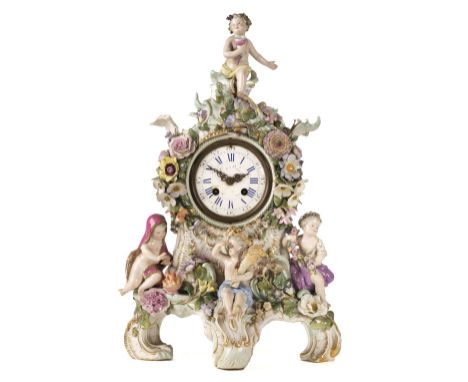 Meissen Clock. A Meissen porcelain mantel clock circa 1890, the case heavily encrusted with flowers, surmounted by a bachanna