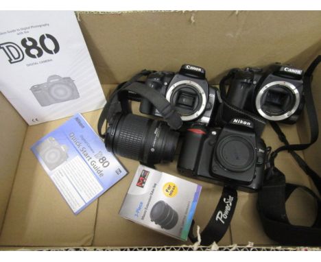 Nikon D80 with booklet and charger, Nikon 18-135mm lens, Nikon extension tubes and 2 Canon camera bodies 400D ( no batteries)